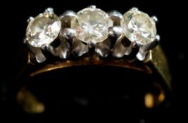 Jewellery: a yellow metal ring, marked 18ct and testing as gold, set with three diamonds totalling a