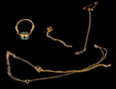 Jewellery: an Egyptian yellow metal ring, testing as 18ct gold, the swivel head set a faience scarab