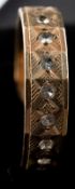 Jewellery: a 9ct yellow gold full eternity ring set with white stones, UK size P, 3.2g.