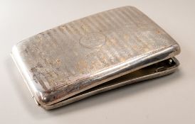Silver: a curved cigarette case, Birmingham 1918, with regular all over engraving and a presentation