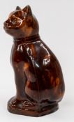 Ceramics: A slipware figure of a cat, 19th century, seated on its haunches with head slightly turned
