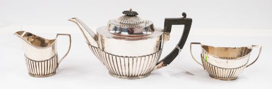 Silver: a three piece half gadrooned tea set, teapot and cream jug by Mappin and Webb, Sheffield 191