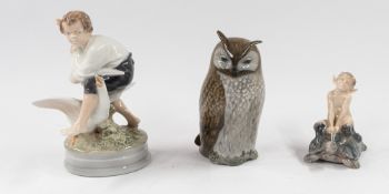 Ceramics: three Royal Copenhagen figures, 20th century, one of a young boy with two geese, another o