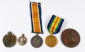 Militaria: Two WWI medals, a cap badge, a bronze medallion Joseph Whitworth and a gold-plated round 