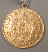 Coins: an 1868 Napoleon III 20 Franc gold coin, with attached suspension loop, 6.5g.