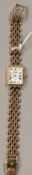 Watches: a ladies 9ct gold cased wristwatch by Soude, with integral gold strap. 17cm long, 16.6g gro
