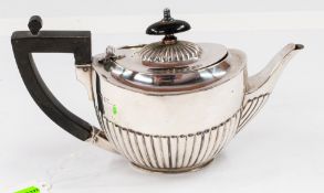 Silver: a bachelors half gadrooned teapot, marks illegible, 20.5cm, 279g.