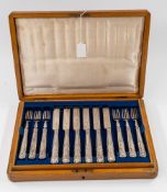 Silver: a twelve setting Kings pattern fruit cutlery set, the blades hallmarked London 1897, the fil