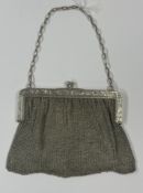 Silver: a sterling mesh handbag, import marks for London 1912, the framework decorated with flowers 