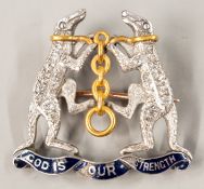 Jewellery: An 18ct gold and platinum diamond and enamel brooch, depicting the arms of the Worshipful