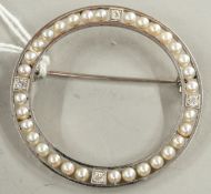 Jewellery: a white metal circular brooch, unmarked but testing as platinum, the frame set with diamo