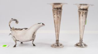 Silver: a sauce boat, Sheffield 1904, with flying scroll handle and standing upon three hoofed feet,
