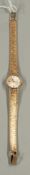 Watches: a ladies 9ct gold Bulova wristwatch with integral mesh strap, circular head diameter 1.9cm 