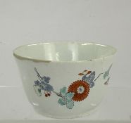Ceramics: a small Chantilly bowl, c.1750, painted in the Kakiemon palette with a spray of Oriental f