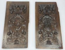 A pair of carved oak panels, 18th century, carved with mask heads wearing elaborate headdresses belo