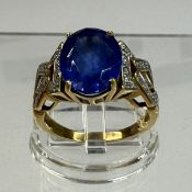 Jewellery: Ring, 18ct yellow gold claw set with an oval tanzanite, estimated weight 3.85ct, each sho