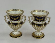 A pair of Copeland two-handled vases, c.1900, of campana form, with spiral gadroon moulding below bl