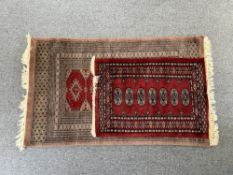 Two Bokhara rugs, mid 20th century, machine made, the larger with geometric designs in red and black
