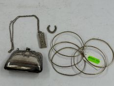 Silver Jewellery: five silver gilt solid bangles, an ingot on a chain, a 'Good Luck' horseshoe and a