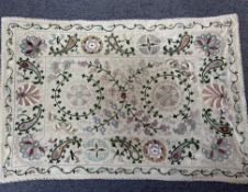 A Suzani rectangular panel, 20th century Uzbek, embroidered in wool with stylised flowers, leaves an