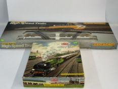 Toys: a Mettoy Railways tinplate clockwork train set, green liveried engine and tender with two red 