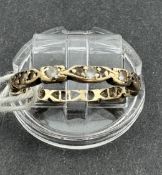 Jewellery: Yellow metal full eternity ring set with white paste, surface tests as 9ct gold, ring siz