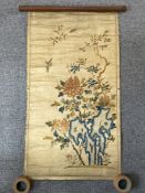 A Chinese embroidered silk scroll hanging, 19th century, brightly decorated with song birds in fligh