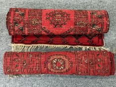 A pair of hand-knotted Anatolian prayer rugs, Pakistan c.1970s, with a geometric design in red and b