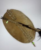 Tribal Arts: a Zulu cow hide ishilangu shield, 67cm by 42cm, together with two ceremonial staffs or 