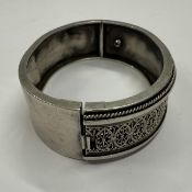 Jewellery: Silver items including, a hinged bangle, front engraved with oval decoration, one full et