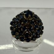 Jewellery: Yellow metal turban-style cluster ring set with forty-nine circular-cut sapphires, estima