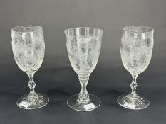 A pair of Victorian wine glasses, c.1860-80, the bowls finely engraved with spiralling bands of frui