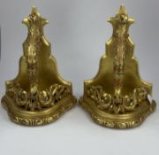 A pair of large gilt wood wall brackets, 19th century, carved with griffin heads surrounded by scrol
