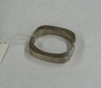 Jewellery: a hinged silver cuff bracelet, import marks for London 1988, untraced makers mark of NJS,
