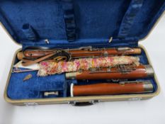 A vintage bassoon, mid century, contained in a fitted case with accessories, with fabric outer case.