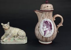 A Ludwigsburg figure of a cat, c.1770, recumbent on a chamfered rectangular base, blue crowned CC ma