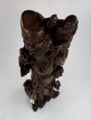 A Chinese mid century rootwood carving of Shou Lao, a small child on his shoulder, 53cm.