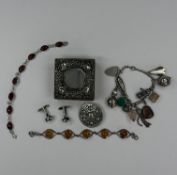 Jewellery: Silver charm bracelet with twelve charms attached, two silver snd amber bracelets, a circ