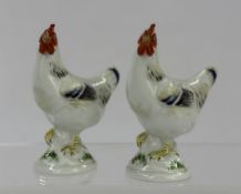 Two miniature Meissen figures of chickens, modern, modelled with red combs and wattles, raised on lo
