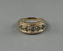 Jewellery: 15ct gold graduated half hoop ring set with five marquise-cut blue topaz, estimated weigh