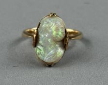 Jewellery: Yellow metal ring set with an opal cameo13.mm x 8.2mm depicting a lady’s head facing left