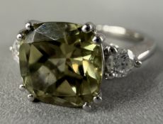 Jewellery: a white metal three stone ring, marked PT 950 and testing as platinum, a central AAAA tur