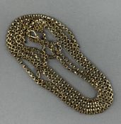 Jewellery: Yellow metal long guard box link with a swivel fastener, length 155cm, surface tests as 9