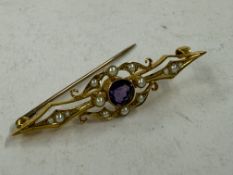 Jewellery: an early 20th century yellow metal bar brooch, marked 15ct and testing as gold, set with 