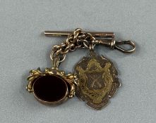 Jewellery: a 9ct rose gold short chain with T bar, attached a 9ct gold 1908 rifle competition medal,