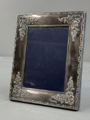 Hallmarked Silver: photograph frame, with ribbon and floral decoration, blue velvet back and strut, 