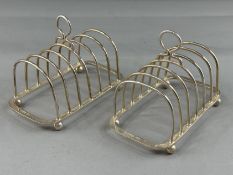 Silver: a pair of six slot wirework toast racks, Sheffield 1966, each with ring handle and standing 