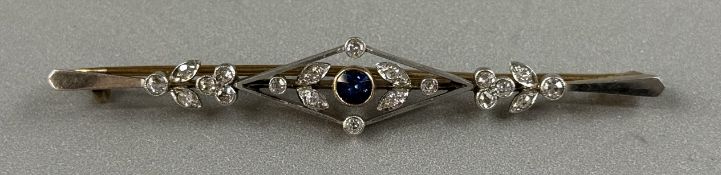Jewellery: Yellow and white metal bar brooch with a kite-shaped centre, set with a single circular c