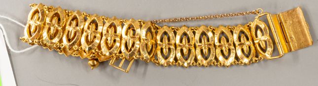 Jewellery: a yellow metal panel bracelet, bearing indistinct Chinese marks to the clasp and testing 