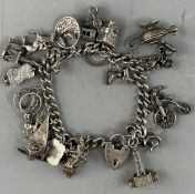 Jewellery: a curb link bracelet, the heart shaped clasp marked Sterling and 'GJ Ltd', suspended with